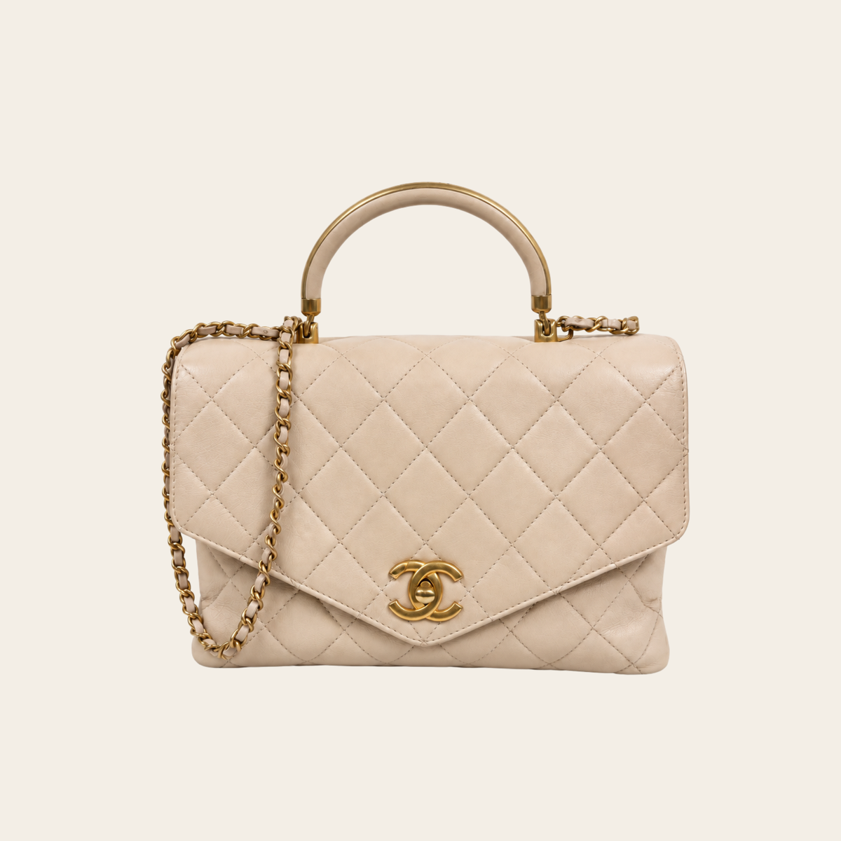 Chanel – Sac Coco Handle CC Top Handle en cuir matelassé beige