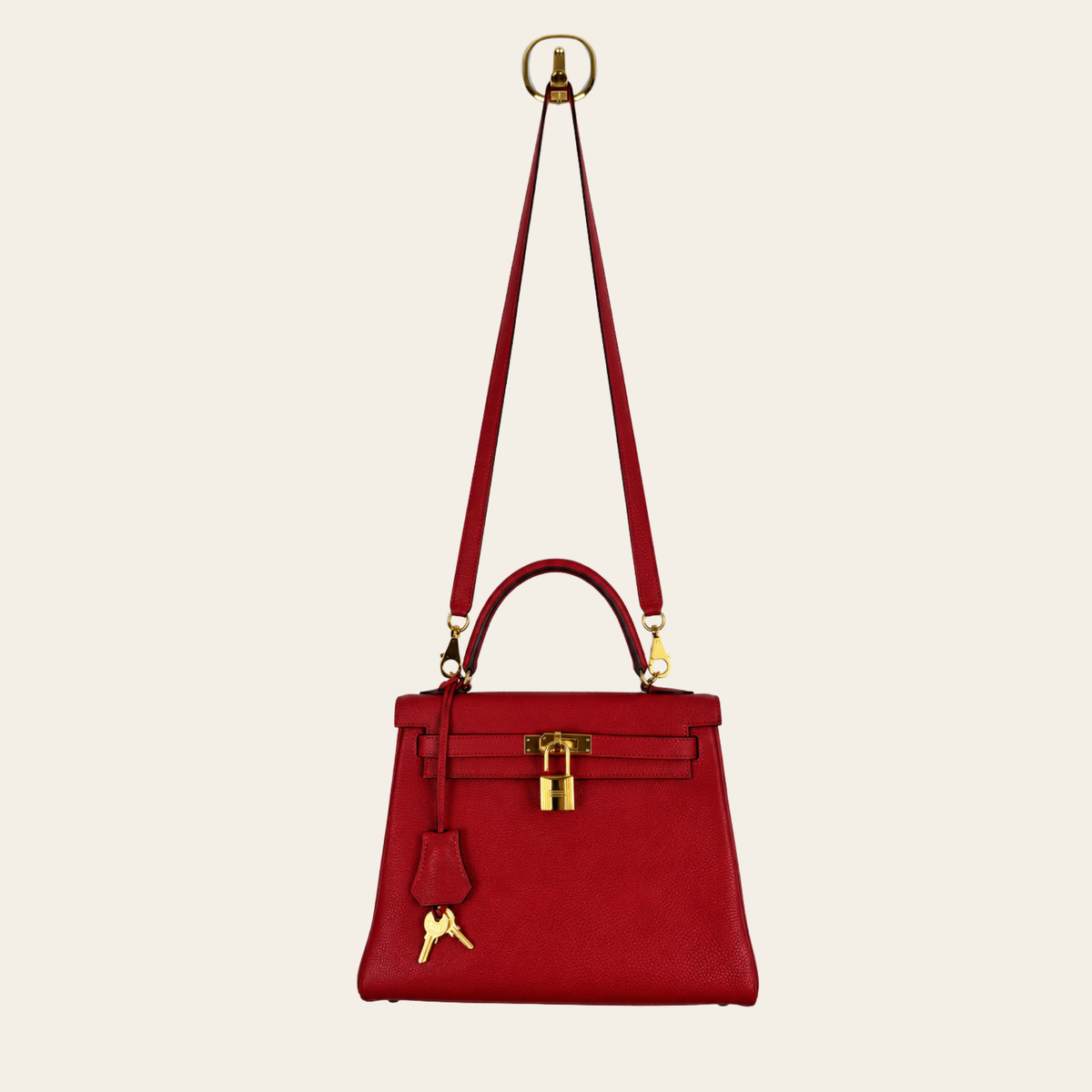 HERMÈS — Kelly 25 Retourne en cuir Togo rouge, quincaillerie dorée