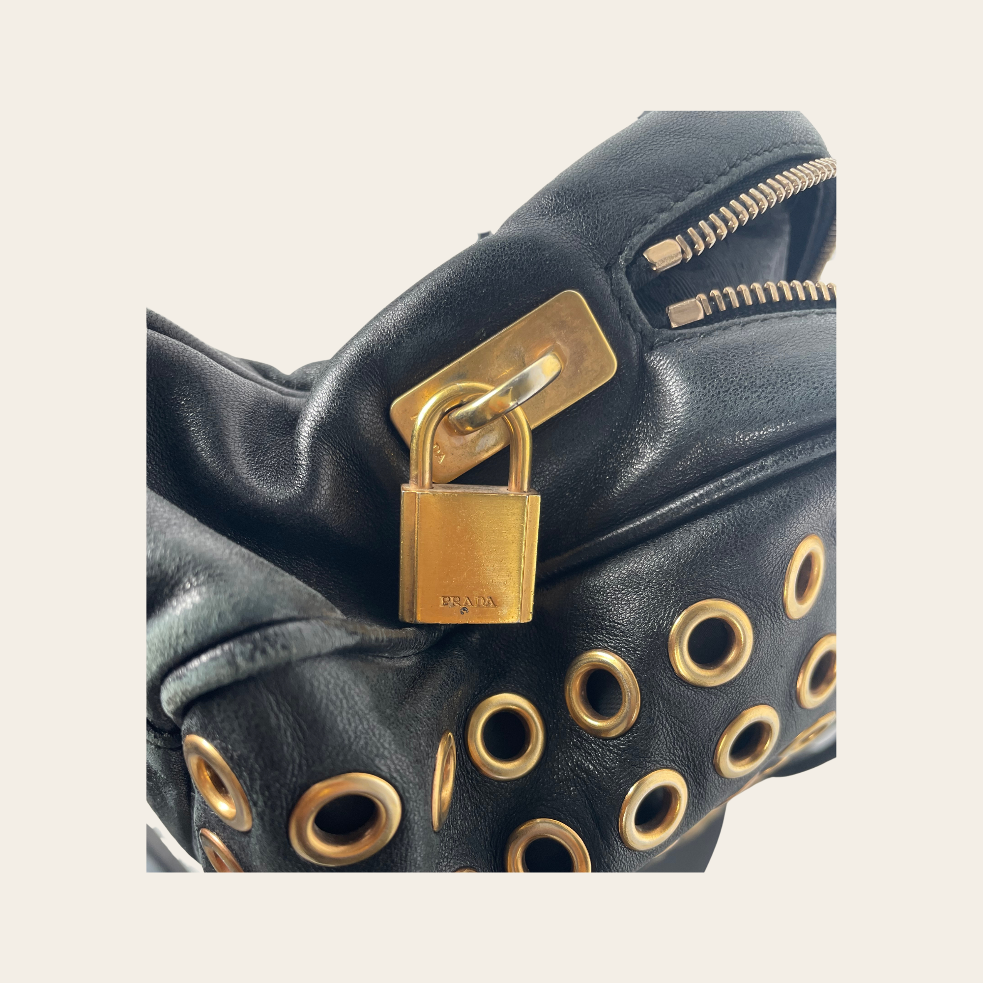 Prada - Vitello Grommet Baguette Bag